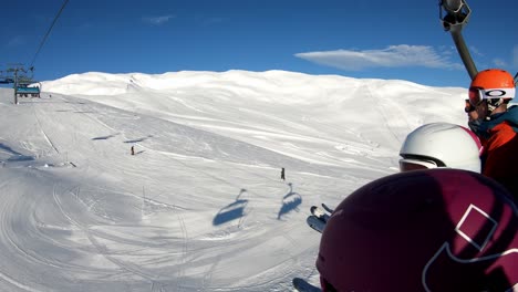 Family-rides-ski-lift-to-top-of-run-at-Myrkdalen-Resort,-Western-Norway