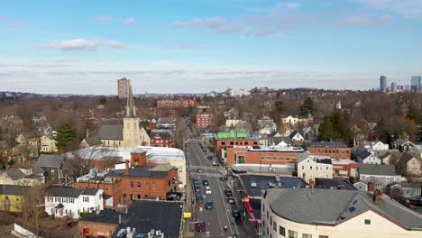 Drone-flying-though-a-small-downtown-area-in-Boston,-Massachusetts-on-a-spring-day