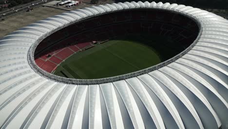 Approaching-Estádio-Beira-Rio-modern-oval-soccer-field-stadium-aerial-view,-Porto-Alegre,-Brazil