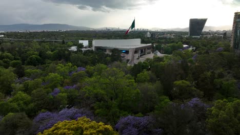 Aerial-view-rising-toward-the-Auditorio-Nacional,-partly-cloudy-day-in-Mexico-city