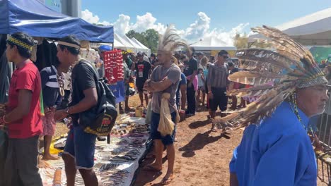 An-older-indigenous-amazon-man-walks-by-with-a-beautiful-feather-hat-with-large-plumes