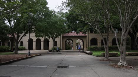 Quad-pathway-on-the-campus-of-Louisiana-State-University-with-students-walking-and-riding-scooters-with-stable-video