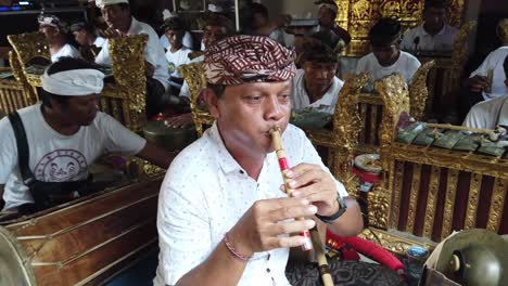 Músico-Gamelan-Balinés-Toca-Suling,-Flauta-De-Bambú-Tradicional-En-Una-Ceremonia-Religiosa-Hindú-De-Bali,-Indonesia,-Sudeste-Asiático