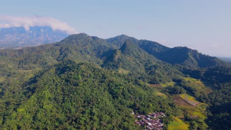 Aerial-Cinematic-clip:-Drone-flying-over-Indonesian-countryside-landscape,-village,-plantation,-forest-and-hills
