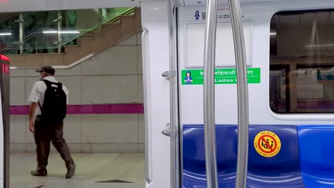 passenger-deboarding-at-metro-station-from-metro-train-arriving-and-automatic-entrance-door-closing-video-is-taken-at-new-delhi-metro-station-new-delhi-india-on-Apr-10-2022