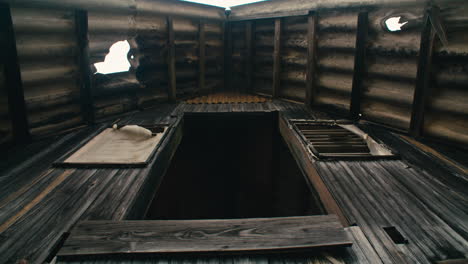Abandoned,-broken-zinc-roofed-triangle-log-cabin