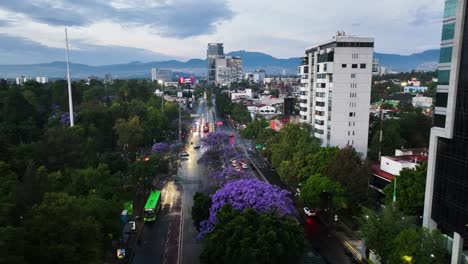 Aerial-view-tracking-over-wet-streets,-spring-evening-in-downtown-Mexico-city