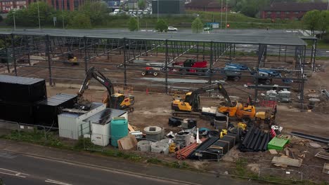 ALDI-supermarket-construction-building-site-aerial-view-descending-industrial-framework-development,-UK