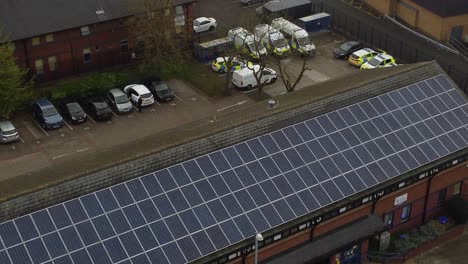 Police-station-with-solar-panel-renewable-energy-rooftop-in-Cheshire-townscape-aerial-view-looking-down-at-parking