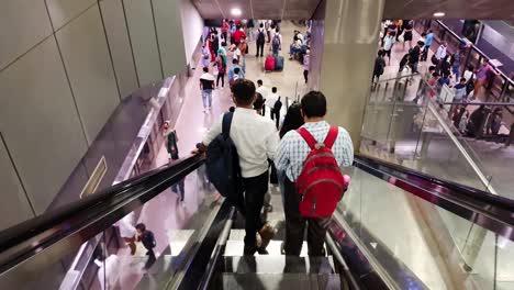 people-standing-on-moving-escalator-from-top-angle-at-morning-video-is-taken-at-new-delhi-metro-station-new-delhi-india-on-Apr-10-2022