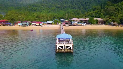 Revealing-aerial-shot-of-ferry-dock-stage-in-Tioman-Island,-Malaysia
