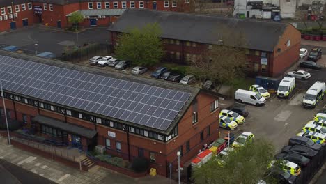 English-town-police-station-with-solar-panel-renewable-energy-rooftop-in-Cheshire-aerial-orbiting-view