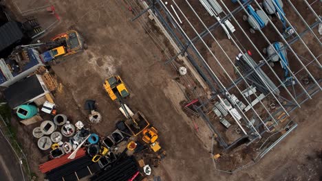 ALDI-supermarket-construction-building-site-aerial-Birdseye-view-orbiting-industrial-framework-development,-UK