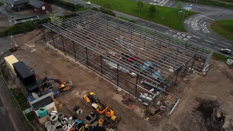 ALDI-supermarket-construction-building-site-aerial-static-view-over-industrial-framework-development,-UK
