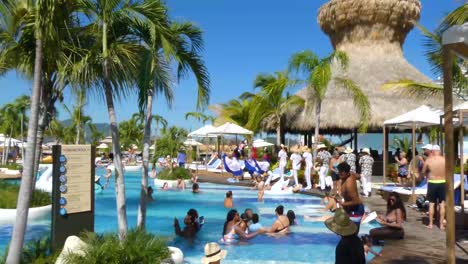 Tourists-at-the-pool-and-Street-performers-in-Taino-Bay,-Puerto-Plata,-Dominican-Republic