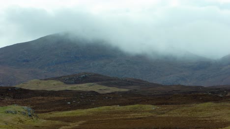 Shot-of-a-foggy-mountain-range-behind-a-peatland-moor-covered-in-heather