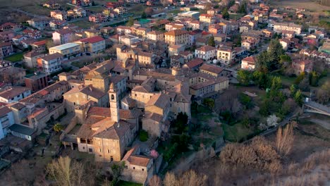 Aerial-drone-orbiting-footage-at-sunset-of-Travo-old-Village-in-Trebbia-River-Valley,-Piacenza,-Italy