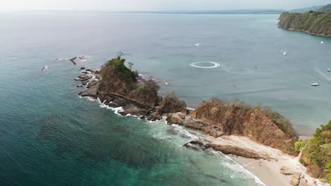 Aerial-landscape-of-a-rocky-cliff-in-the-tropical-beach-of-Playa-Blanca-in-Costa-Rica