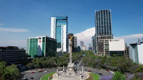 Drone-Shot-Of-Jacaranda-And-Angel-De-La-Independencia-In-Paseo-De-La-Reforma-In-Mexico-City