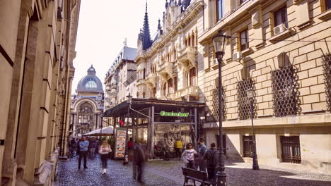 Old-town-streets-with-restaurants-and-tourists-and-CEC-Palace-in-the-background,-Bucharest-Romania
