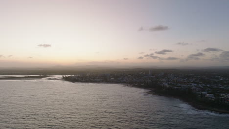 Sunset-Drone-Flyover-Sunshine-Coast-Beach-Town-And-Ocean-Coastline,-4K-Australia