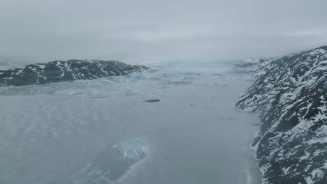 Vista-Aérea,-Agua-Congelada-E-Icebergs,-Laguna-Glaciar-Jökulsárlón-En-Temporada-De-Invierno,-Islandia,-Tiro-Con-Drones