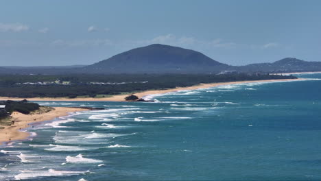 Blue-Ocean-Waves-And-Sandy-Shore-Coast-Overlooking-Mount-Coolum-Mountain,-4K-Aerial-Drone-Australia-Telephoto