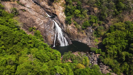 Menschen-Schwimmen-Im-Fluss-Unter-Dem-Dudhsagar-Wasserfall-In-Indien---Drohnenaufnahme-Aus-Der-Luft
