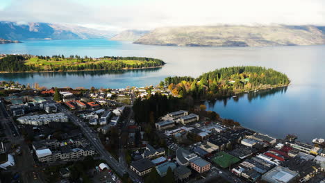 Aerial-view-of-Queenstown,-along-Lake-Wakatipu-with-stunning-sunlight