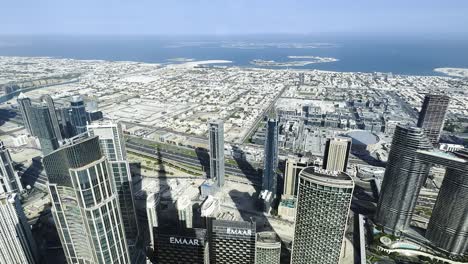 Slow-zoom-in-shot-looking-over-downtown-Dubai-from-the-Burj-Khalifa,-Dubai