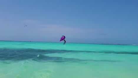 Woman-silhouette-begin-to-Fly-Upwind-wing-foil-kite,-extreme-sport-on-azure-caribbean-sea