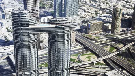 Slow-motion-shot-looking-over-Sheik-Zayed-Road-Intersection-from-the-Burj-Khalifa,-Dubai