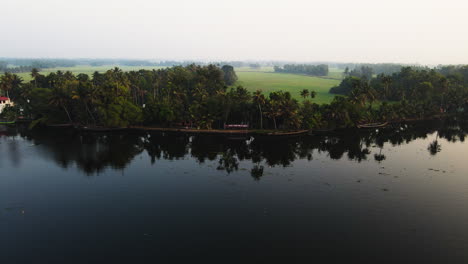 Reflections-On-Lagoon-With-Rural-Fields-Near-Alleppey-Town-In-Kerala,-India