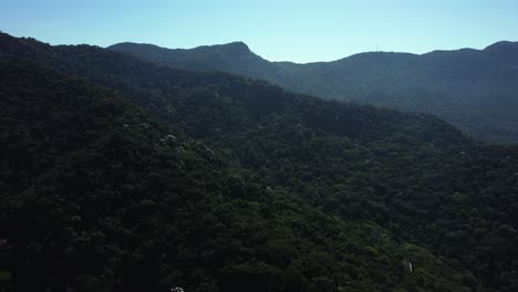 Aerial-view-flying-over-mountains-and-jungle,-sunny-day-in-Rio-de-Janeiro,-Brazil