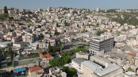 Aerial-tilts-uphill-in-old-town-neighbourhood-of-Nazareth,-Israel