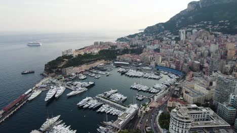 Monaco-City-Port-with-Yachts-and-Boats,-Establishing-Tilt-up-Aerial-Landscape
