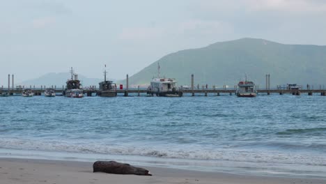 Ocean-Scenic-View-Of-The-New-Pier-From-Shore-With-Mountains-In-Background-At-Con-Dao-In-Vietnam