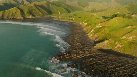 Golden-sunshine-lights-up-coastal-landscape-of-New-Zealand-at-Kiritehere-beach