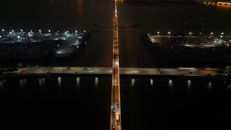 Tilt-up-aerial-view-over-bridge-revealing-Taipa,-Macau