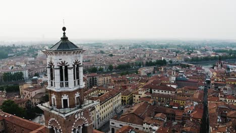 Aerial-view-of-Palazzo-della-Ragione-standing-high-above-Verona,-Italy-on-an-overcast-day