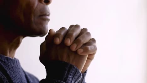 man-praying-to-god-with-hands-together-Caribbean-man-praying-with-background-with-people-stock-footage