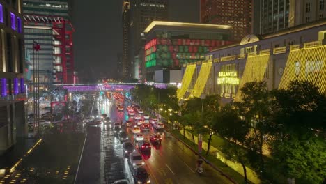 Aerial-establishing-shot-of-Taipei-City-with-shopping-center-in-rain-during-Christmas-season-with-decorated-facade