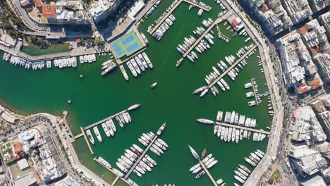 Topdown-ascending-view-of-Marina-Zeas,-yachts-moored-in-the-piers,-Athens