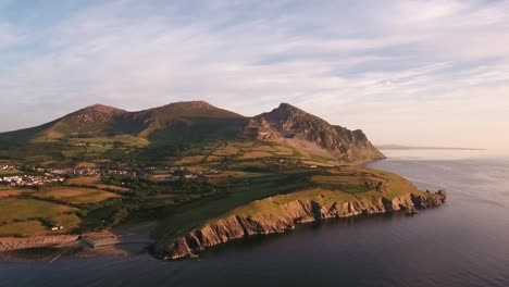 Aerial-approach-to-Mountain-range-Yr-Eifl-at-Trefor-with-blue-skies-on-a-summers-day-across-the-Irish-Sea-on-the-Llyn-Peninsula-in-North-Wales