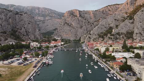 Boats,-Yachts-and-Car-Parking-lots-at-wharf-of-Cetina-River-mouth-in-Omis-town,-Croatia