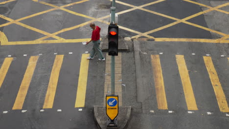 People,-homeless-beggar-crossing-the-yellow-pedestrian-crosswalk,-Top-view