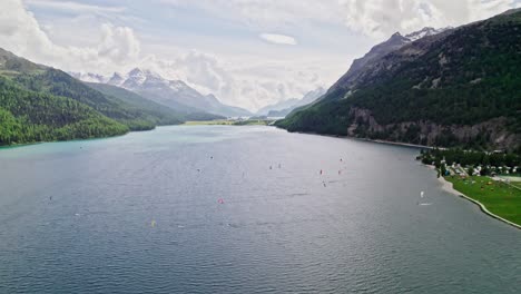 Stunning-aerial-captures-kitesurfers-on-Lake-Silvaplana,-framed-by-majestic-mountains