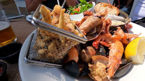 Close-up-shot-of-fish-platter-served-in-an-outdoor-mediterranean-restaurant-in-Marsaxlokk,-Malta-at-daytime