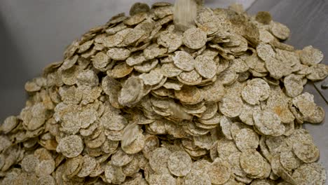 Close-shot-of-a-stacking-einkorn-chips-on-a-pile