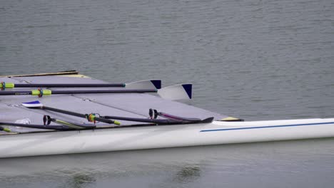 Pier-on-the-water-with-oars-and-modern-double-sculls